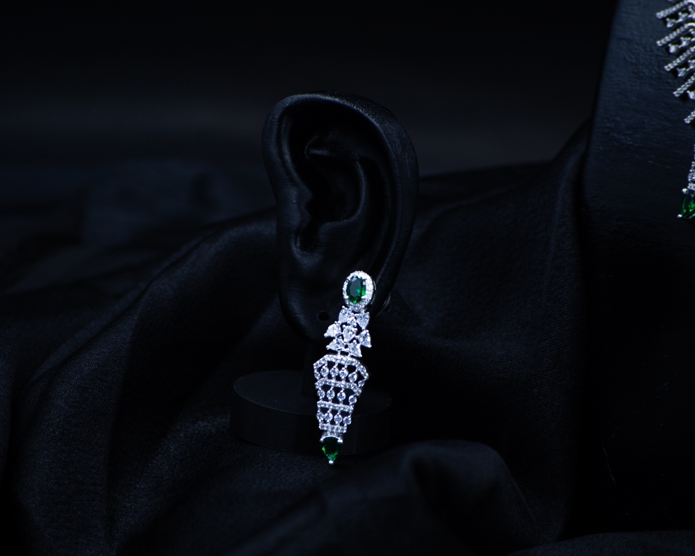 Green Set earring with green stones on black display