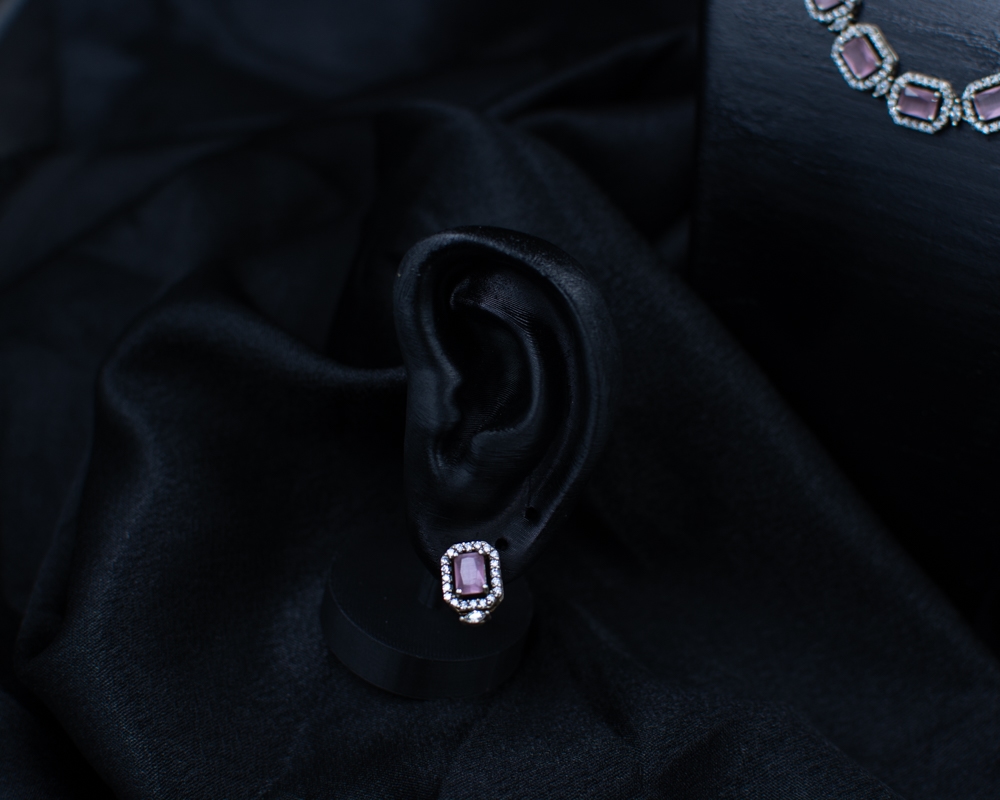 Purple Set earring with square purple stone on black display