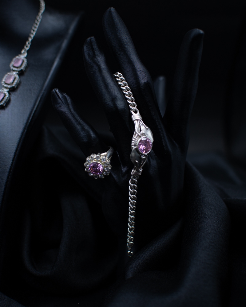 Purple Set ring and bracelet with purple stones on black hand display