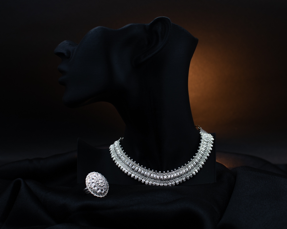 Silichung necklace and statement ring on dark satin