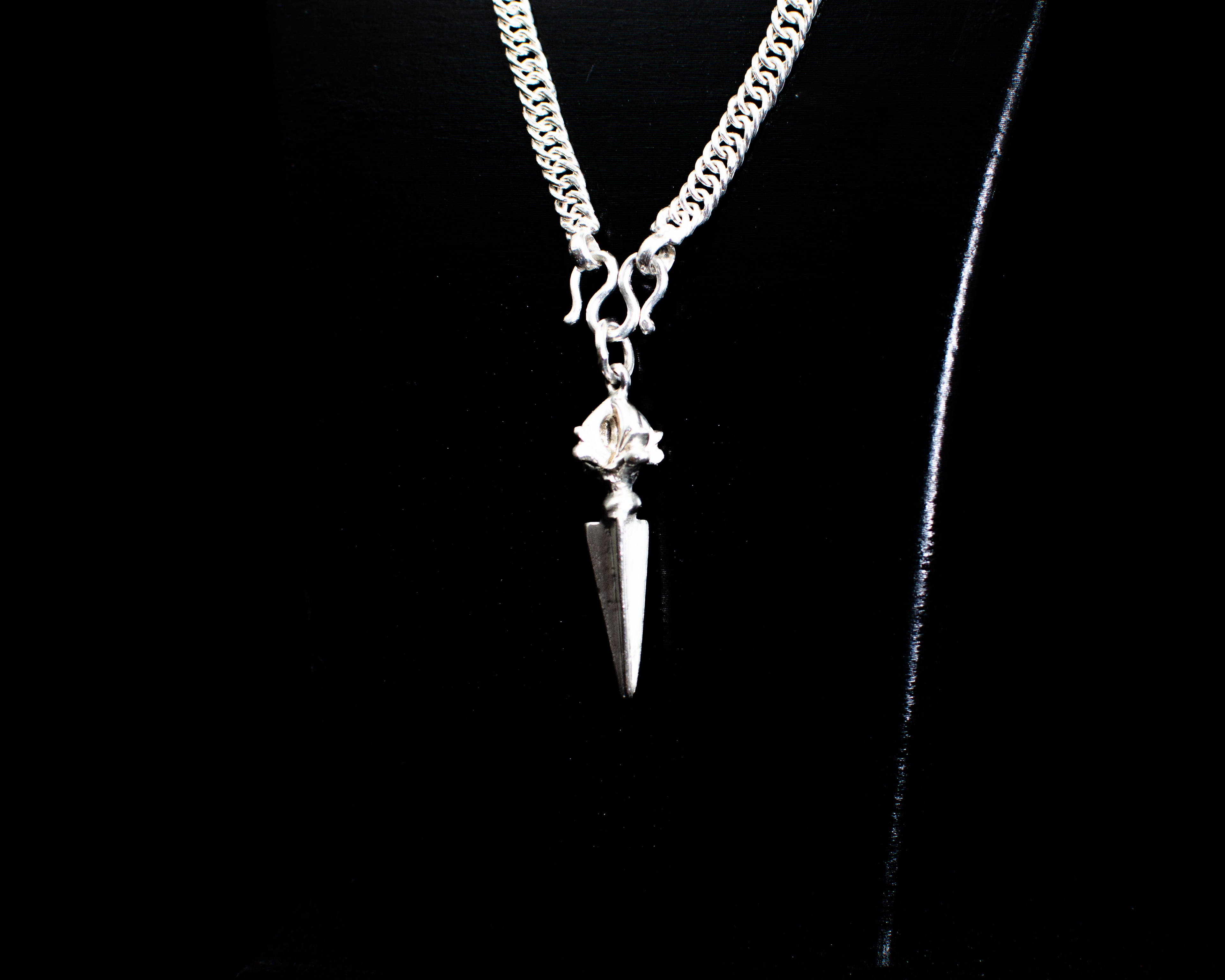 The Phurba Vajra Pendant on a black necklace bust