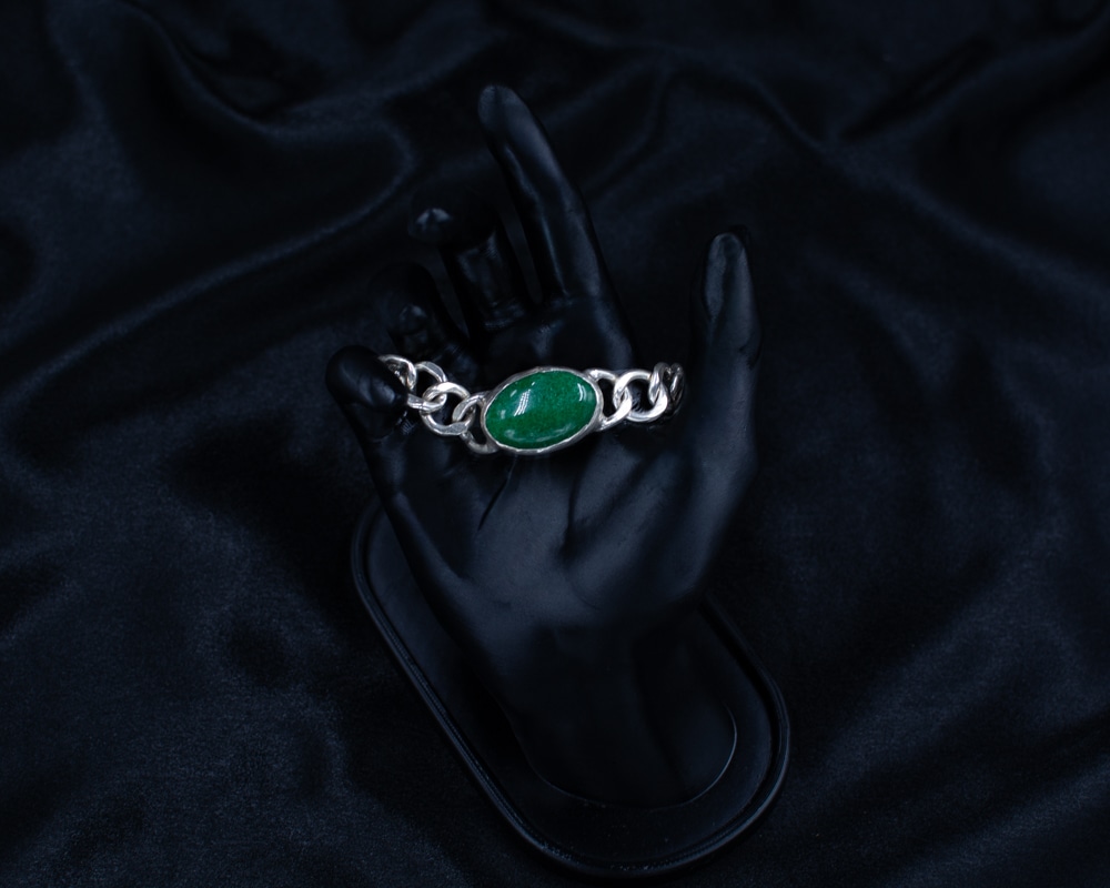 Green Bracelet with oval green stone on black hand display